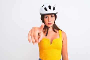 Young beautiful cyclist girl wearing bike helmet standing over isolated white background pointing with finger to the camera and to you, hand sign, positive and confident gesture from the front
