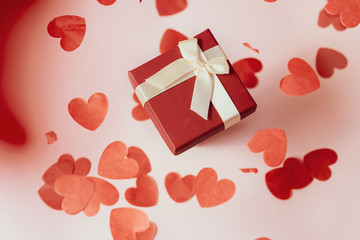 Present or gift box, paper heart and confetti on Valentines day greeting card.