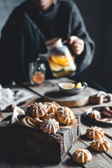 Woman is pours Hot tea with fresh grapefruit on wooden tablet. Healthy drink, Eco, vegan.