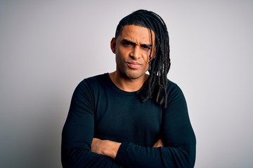 Young handsome african american man with dreadlocks wearing black casual sweater skeptic and nervous, disapproving expression on face with crossed arms. Negative person.