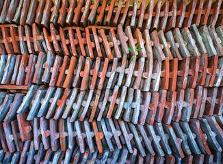 Sorted stacks of old roof tiles in a yard