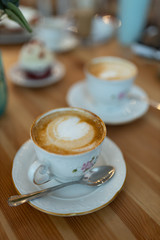 Close-up cup of coffee with foam drawing