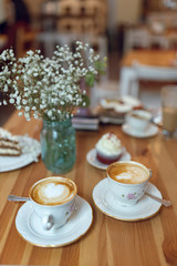 Close-up cup of coffee with foam drawing