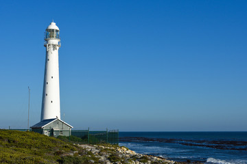 Tall White Lighthouse Overlooking The Ocean, Cape Town, South Africa