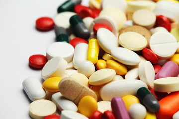 Different colorful tablets at white background	