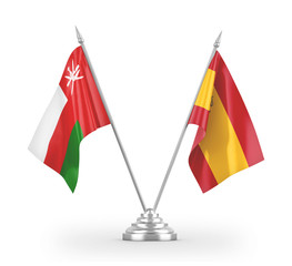 Spain and Oman table flags isolated on white 3D rendering