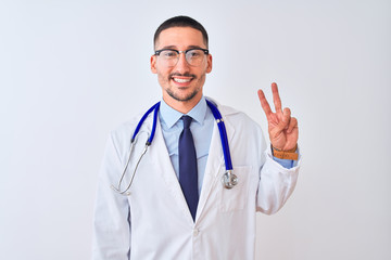 Fototapeta premium Young doctor man wearing stethoscope over isolated background showing and pointing up with fingers number two while smiling confident and happy.