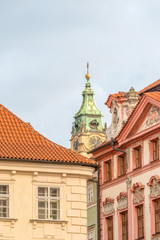 Fototapeta na wymiar View of the top of old buildings with red roof and dramatic sky at Prague city Czech republic.