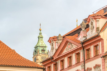 View of the top of old buildings with red roof and dramatic sky at Prague city Czech republic.