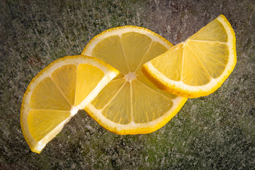 Lemon slices on ice with bubbles