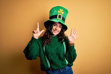 Beautiful curly hair woman wearing green hat with clover celebrating saint patricks day showing and...