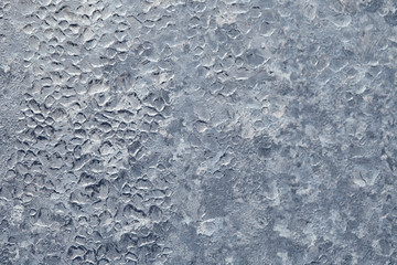 Frozen drops of condensed steam water drops on the transparent window glass. Clean background. Condensation of moisture at extreme temperatures. Water vapor condenses on cold window glass and freezes