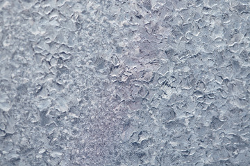 Texture of Frozen drops of condensed steam water drops on the transparent window glass. Clean background. Water vapor condenses on cold window glass and freezes into ice