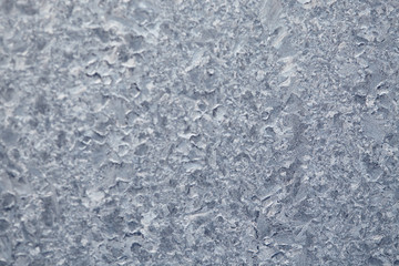 Frozen drops of condensed steam water drops on the transparent window glass. Clean background. Condensation of moisture at extreme temperatures. Water vapor condenses on cold window glass and freezes