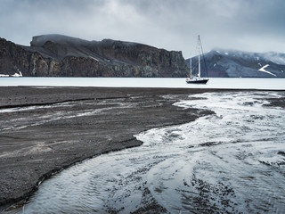 alone yacht in harbour and river under clouds