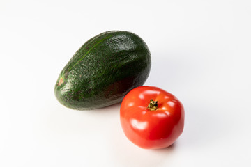 Tomato and avocado on white background