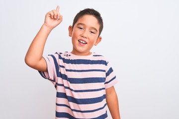 Beautiful kid boy wearing casual striped t-shirt standing over isolated white background pointing finger up with successful idea. Exited and happy. Number one.