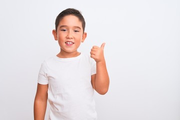 Beautiful kid boy wearing casual t-shirt standing over isolated white background doing happy thumbs up gesture with hand. Approving expression looking at the camera showing success.