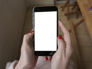 Woman hand with red nail varnish, is touching mobile phone, tablet with green screen, chroma key. Technology concept mock up with tracking markers.