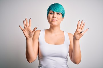 Young beautiful woman with blue fashion hair wearing casual t-shirt over white background showing...