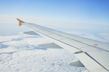 Fototapeta na wymiar Cloudscape from window airplane, landscape of wing plane on a cloudy sky
