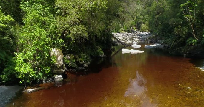 4k forward tracking low angle aerial view of the Oparara River in the Oparara Basin Arches which is situated in the Kahurangi National Park,Karamea,South Island New zealand