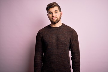 Obraz premium Young blond man with beard and blue eyes wearing casual sweater over pink background looking sleepy and tired, exhausted for fatigue and hangover, lazy eyes in the morning.