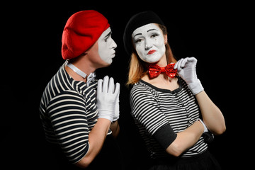 Male and female mime on black background