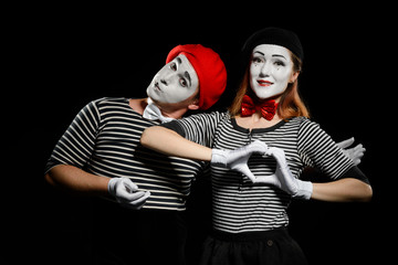 Pretty couple of mimes on black background