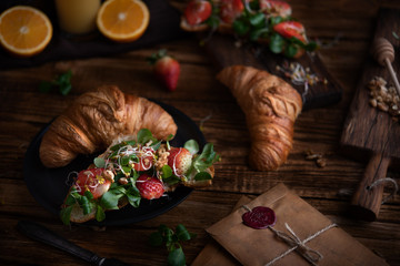 Healthy croissant for breakfast on dark background