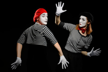 Two mimes and invisible wall. Pantomime show at circus