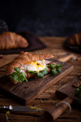 Healthy croissant for breakfast on dark background