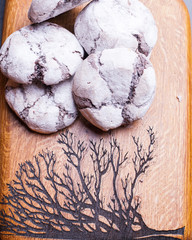 The form for cookies on the wooden board poured by a flour
