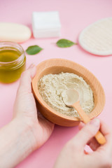 Cosmetic bath salt, grape gomaj for the face, coffee scrub for the body on a pink background.