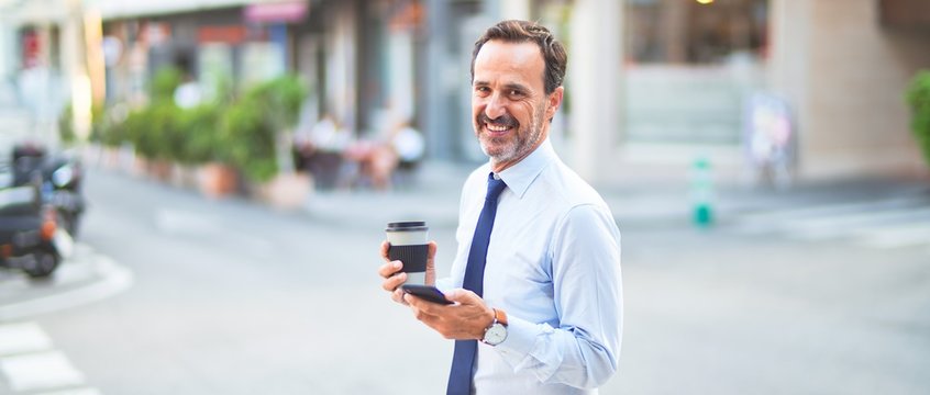 Middle age handsome businessman using smartphone drinking take away coffee smiling