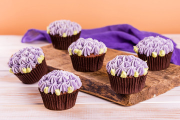 Chocolate cupcakes on a wooden table with salted caramel inside. Dessert.