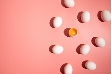 White eggs on pastel pink background. Easter holiday concept.