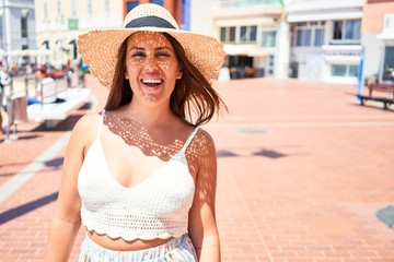 Beautiful young woman walking on beach promenade enjoying ocean view smiling happy on summer vacation