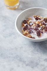 Bowl of granola with yogurt, nuts, cranberry and cocoanut. Concept for a tasty and healthy meal. Stone  background. 