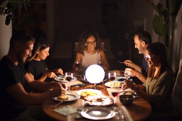 Beautiful family on dinner talking and smiling at terrace