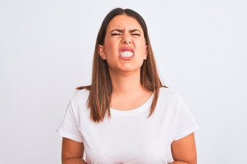 Portrait of beautiful and young brunette woman standing over isolated white background with hand on stomach because indigestion, painful illness feeling unwell. Ache concept.