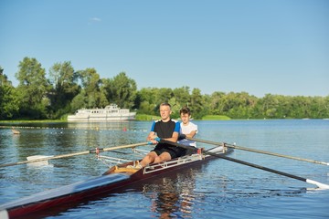 Active healthy lifestyle teens. Boys paddling sport kayak