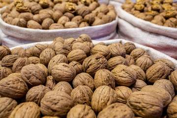 Stack of shelled walnuts in sack