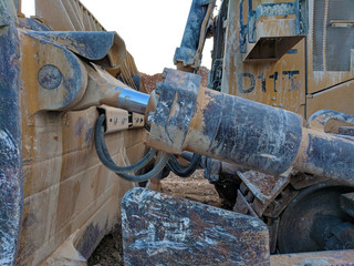 Muddy Caterpillar D11 Bulldozer - Hydraulic Actuator Detail at Sunset