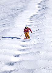 People are enjoying mogul skiing snow boarding	