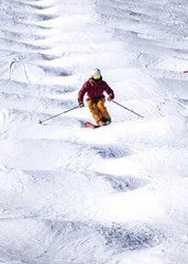 People are enjoying mogul skiing snow boarding	
