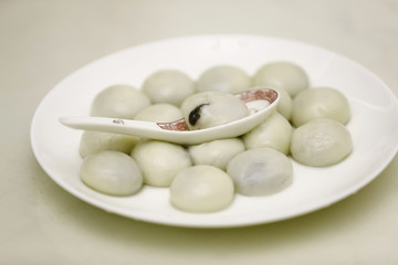 A plate of yuanxiao is on the table