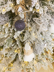 Close-up christmas tree with snow and decorations