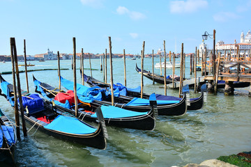 Fototapeta na wymiar Venetian boats, gondolas, moored in harbor, near St Mark's Square, Venice, Italy