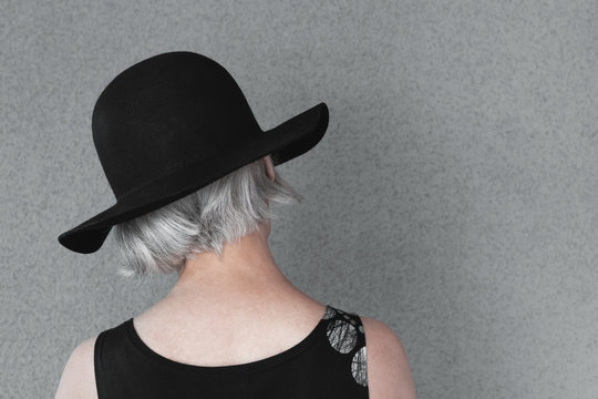 Lady with gray hair in black hat